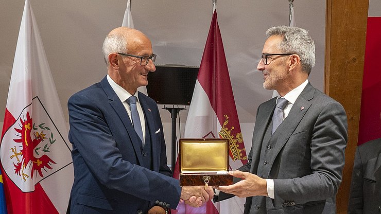 © USP/Daniel von Johnston L simbol dla presidënza dl’Euregio: ai 25 de setëmber 2025 ti à l presidënt dla Jonta provinziela de Bulsan Arno Kompatscher, a man drëta, sëurandat al capitan dl Tirol Anton Mattle la tle storica dla Cësa Waag, sënta dl’Euregio a Bulsan.