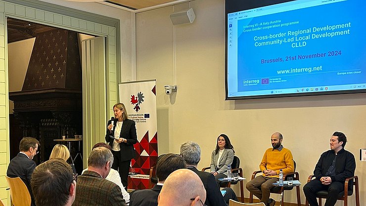 Martha Gärber, standing, speaks during the conference. Seated next to her are Irene Covi, Peter Luis Thaler and Sebastian Vicoli. 