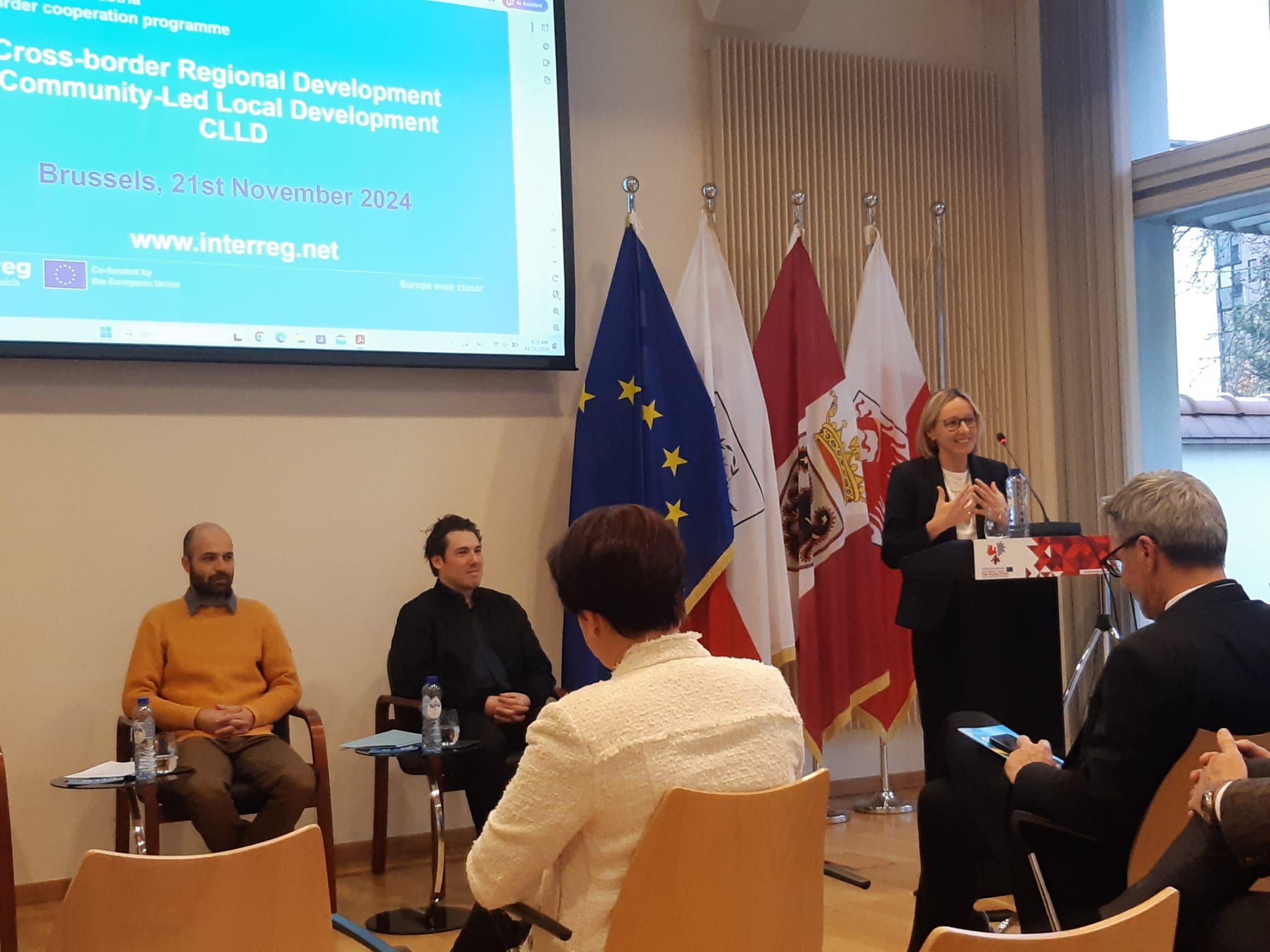 At the podium, South Tyrolean Councillor Magdalena Amhof speaks to the room.